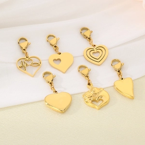Set of six gold stainless steel heart pendants with lobster clasps on white silk background
