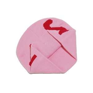 Detailed close-up of pink knit beanie featuring red number two jacquard pattern and texture
