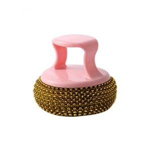 Kitchen cleaning brush with pink handle and golden metal scouring ball on white background