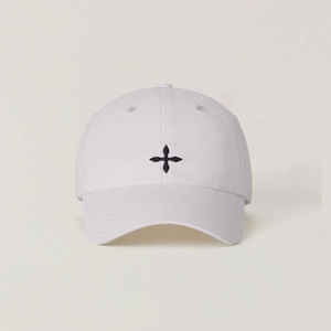Detailed close-up of white cotton baseball cap with black cross embroidery and stitched eyelets