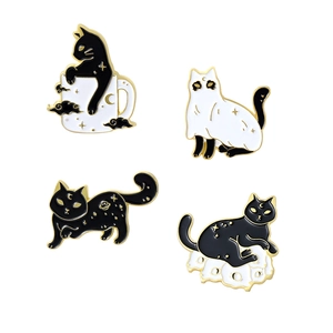 Set of four creative black and white cat enamel pins with celestial and ghost designs