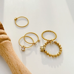 Set of 18K gold plated stackable titanium rings with twisted bands and zircon inlays