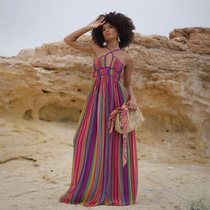 Detail of bohemian rainbow striped maxi dress featuring a halter neck and flowing fabric