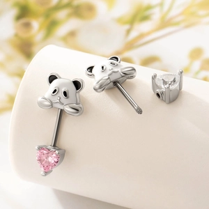 Orecchini a panda in acciaio al titanio con cristalli rosa a cuore su espositore