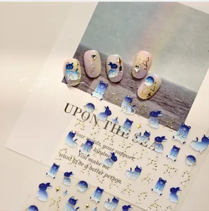 Detail of 3D cartoon nail stickers featuring blue planets, rabbits and cats on nails