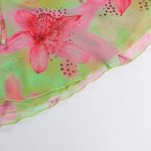 Detail of floral print mesh fabric with high-quality lettuce edge hem on summer dress