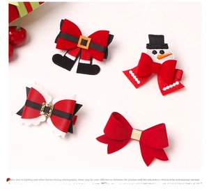 Detail view of 4 festive Christmas hair clips featuring Santa, snowman and red sequins