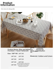 Detailed macro of Chinoiserie blue floral cotton linen tablecloth with white tassels