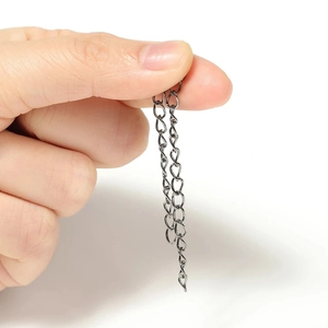 Gun black stainless steel extension chain accessory held between fingers for jewelry DIY