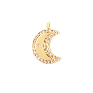 Detail of gold crescent moon pendant with star pattern and clear cubic zirconia stones