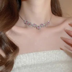 Elegant silver necklace set with pink square zirconia flower pendants on a model