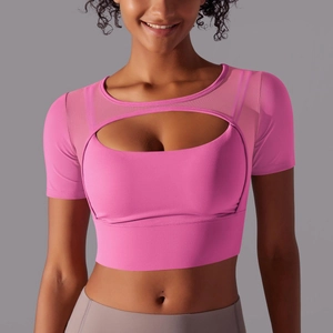 Detail of rose pink cutout sports top with mesh stitching and oval chest opening