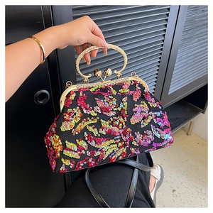 Detail of colorful sequin shell bag with metal handle and shimmering texture