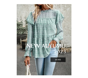Detail of green floral blouse featuring elegant ruffle sleeves and white polka dot pattern
