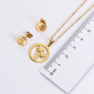 Detailed view of 18k gold coconut tree pendant necklace and earring set with scale reference