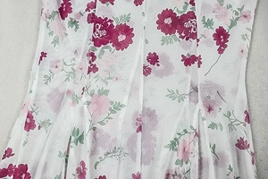 Close-up of floral print on lightweight mesh fabric with purple flowers and green leaves