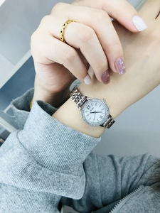 Detail of a silver mesh strap watch with sparkling rhinestones on the wrist