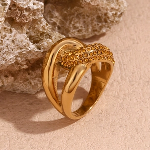 Detail of 18K gold plated knotted ring featuring yellow zircon inlay on natural stone