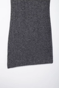 Detailed texture of grey knit fabric on bodycon dress hemline with white background