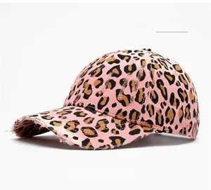 Detail of light pink leopard print baseball cap with vintage distressed brim effects