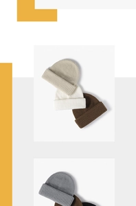 Detailed pile of thick knit beanies in beige, brown, and grey with folded cuffs