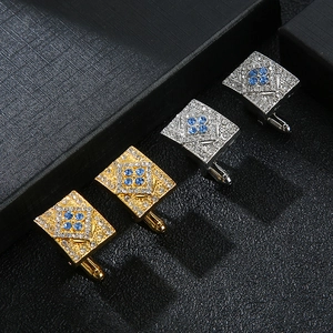 Macro detail of rectangle cufflinks with blue crystal flowers in a display box