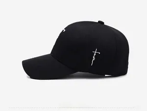 Detail of white Faith embroidery on a premium black cotton twill baseball cap