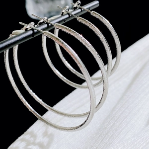 Frosted silver hoop earrings for women with minimalist matte finish on display