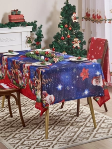 Close-up of festive Christmas tablecloth with Santa Claus and teddy bear pattern on a set table