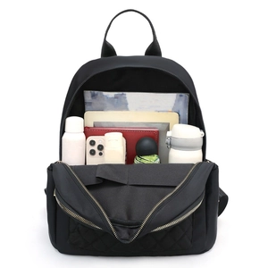 Black quilted oxford backpack with large capacity showing interior storage space and items