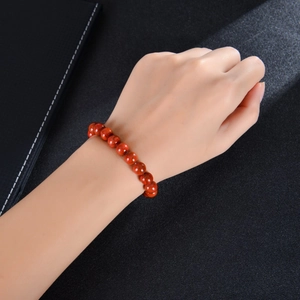 Close-up of red agate beads bracelet with natural textures worn on a wrist