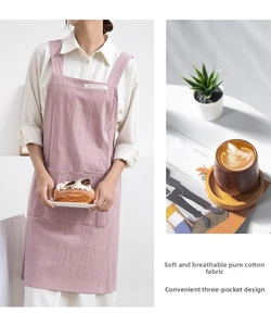 Detail of pink cotton apron showing triple pockets and soft breathable fabric texture