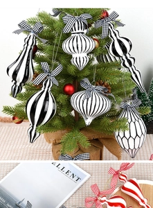 Detail of red and white striped Christmas ornaments with elegant gingham bows on a table