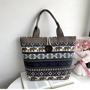 Close-up of ethnic canvas tote bag showing elephant print and boho geometric stripes