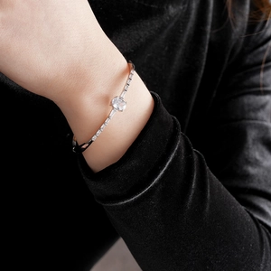 Close-up of silver oval zircon bracelet with rectangular side stones worn on wrist