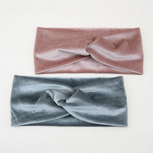 Detail of twisted velvet headbands in dusty pink and blue-gray with soft texture