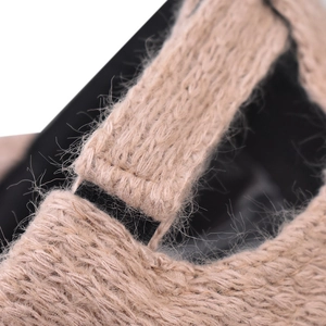Macro detail of plaid baseball cap showing warm knit texture and adjustable back strap
