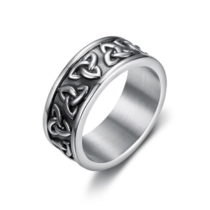 Detail of vintage stainless steel Viking ring featuring Celtic knot relief and antique finish