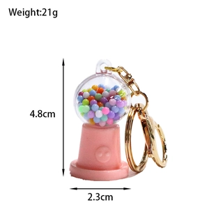Detail showing candy machine keychain dimensions with a height of 4.8cm and 21g weight
