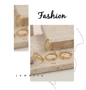 Detail of vintage laser-etched heart and star sunburst rings in gold titanium steel