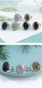 Close-up of vintage silver rings featuring oval gemstones in purple and turquoise colors