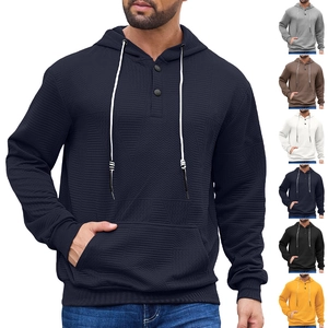 Detail of heavy knit hoodie with wave herringbone texture and buttoned neckline
