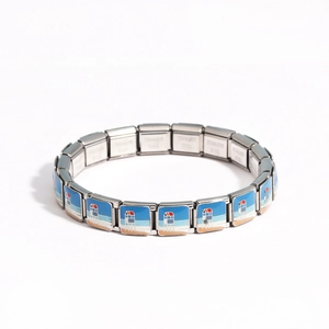 Detail of stainless steel link bracelet featuring coastal beach hut enamel patterns