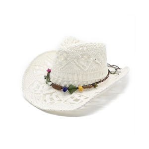 Detail of white woven straw hat with turquoise beads and ethnic pattern trim