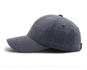 Detail of dark gray plaid baseball cap with fabric texture and side logo tag