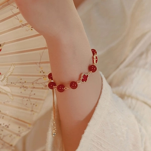 Red agate bead bracelet with golden clover flower pendant and adjustable chain for women