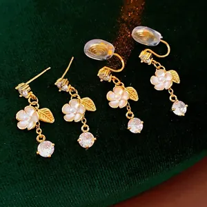 Elegant gold plated floral tassel earrings with white flower petals and zircon drops
