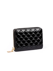 Macro detail of black patent leather wallet with quilted diamond pattern and gold zipper