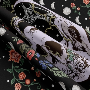 Detail of gothic tapestry showing moon phases and white skull with colorful flowers