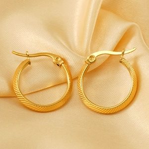 Minimalist gold-plated hoop earrings featuring textured diagonal stripes on champagne silk